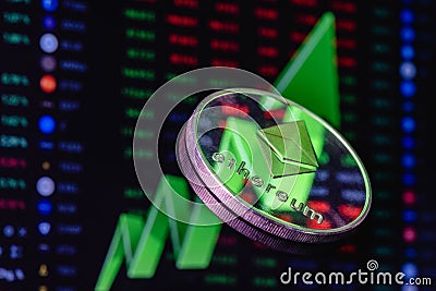 Ethereum coin on the background of a large green arrow pointing up Editorial Stock Photo