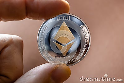Ethereum coin close-up in hands. Blockchain technologies. WEB 3.0 Editorial Stock Photo