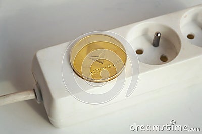 Ethereum coin lying on power strip extension cord with empty socket, cryptocurrency energy consumption and footprint concept Editorial Stock Photo