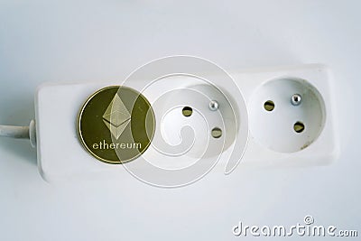 Ethereum coin lying on power strip extension cord with empty socket, cryptocurrency energy consumption and footprint concept Editorial Stock Photo