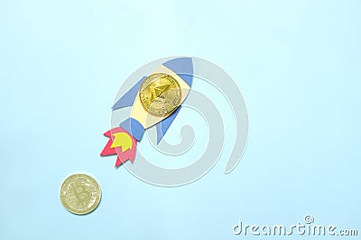 Ethereum coin surpass and overtake Bitcoin coin on rocket paper cutout with copy space. Competition in cryptocurrency and Ethereum Editorial Stock Photo