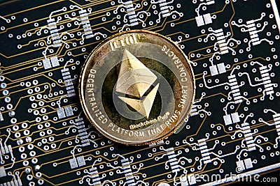 Ethereum ETH gold coin representing cryptocurrencies, against a computer circuit background Editorial Stock Photo