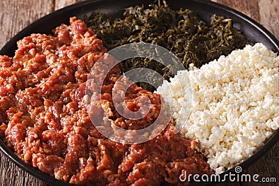 Ethiopian cuisine: kitfo with greens and cheese ayibe macro. horizontal Stock Photo
