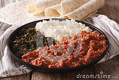 Ethiopian food kitfo: marinated beef with herbs and cheese close Stock Photo