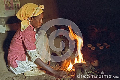 Ethiopian woman is cooking on a wood fire Editorial Stock Photo