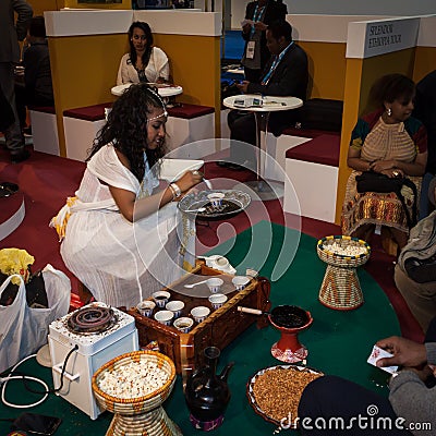 Ethiopian woman serving traditional coffee at Bit 2014, international tourism exchange in Milan, Italy Editorial Stock Photo