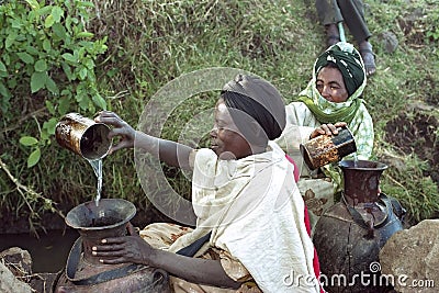 Ethiopian women fetch water from natural well Editorial Stock Photo