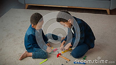 Ethnic African American multiracial multiethnic boys kids schoolboys pupils sons indoors at home children brothers Stock Photo