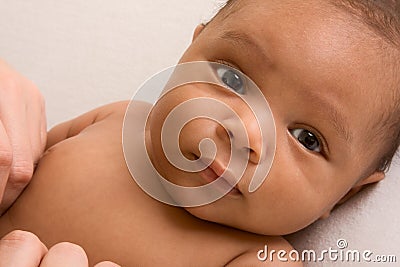 Ethnic baby boy lying down Stock Photo