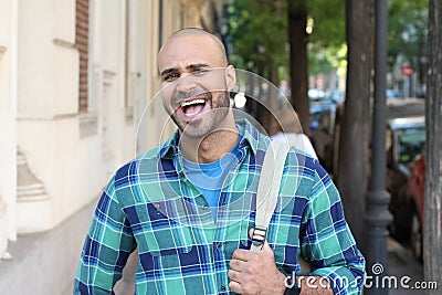 Ethnic man laughing out loud outdoors Stock Photo