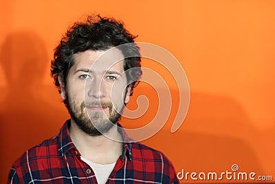 Ethnically ambiguous man in orange background Stock Photo