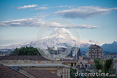 Etna with snow seen from the center of Catania Stock Photo