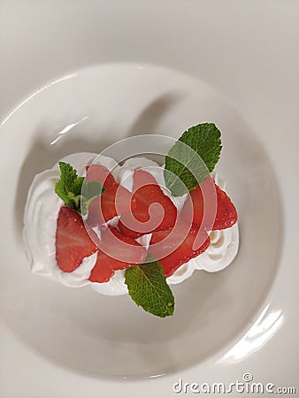 eton mess Fresh Berry Dessert with Mint Leaf on Plate Stock Photo