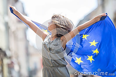 EU Flag. Cute happy girl with the flag of the European Union. Yo Stock Photo