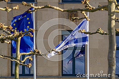 EU and Israeli flags flutter in the wind Stock Photo