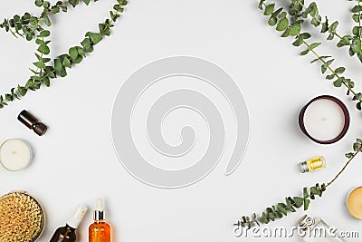 Eucalyptus branches, candles, essential oil, body brush and various beauty products Stock Photo