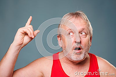 Eureka moment captured in studio! Senior man with finger up and open mouth, showing amazement Stock Photo