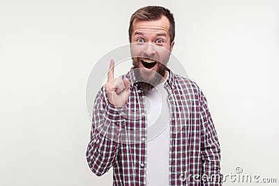 Eureka! Portrait of excited joyful bearded man pointing finger up, looking inspired with found answer. white background Stock Photo