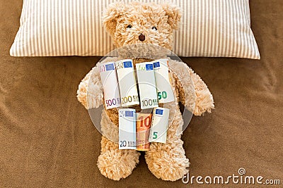 Euro banknote money on soft bear resting on stripe pillow and br Stock Photo