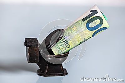 Euro banknotes down to the toilet, concept and symbolic Stock Photo