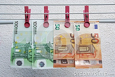 Euro banknotes drying. Washed Euro paper bills. Drying euro on a string. Stock Photo