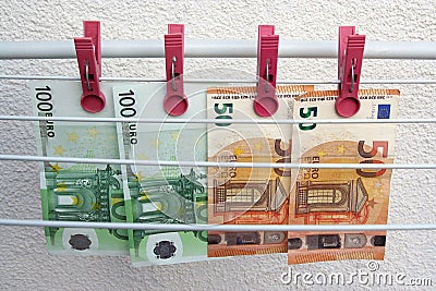 Euro banknotes drying. Washed Euro paper bills. Drying euro on a string. Stock Photo