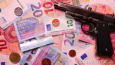 Euro banknotes with a gun Stock Photo