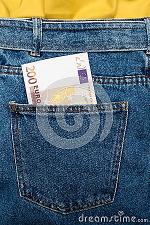 Euro banknotes in jeans back pocket. Forgotten money, nest egg. Concept of saving or spending money. Euro bills falling out. Easy Stock Photo