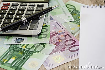500 euro closeup, pen, part of a notepad, calculator and euro banknotes Stock Photo