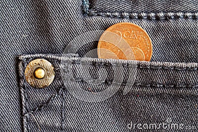 Euro coin with a denomination of two euro cent in the pocket of dark blue denim jeans Stock Photo