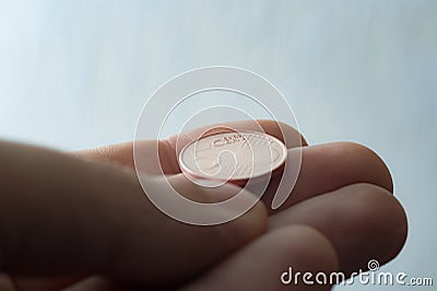 Euro coin on finger tips Stock Photo