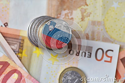 Euro coin with national flag of slovenia on the euro money banknotes background Stock Photo