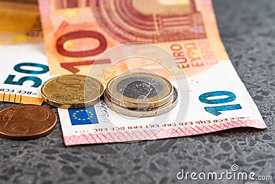 Euro coins and banknotes on stone background Stock Photo