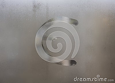 Euro currency symbol draw on fog window glass. Eurozone money sign on frozen glass texture Stock Photo