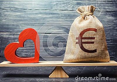 Euro money bag and red heart on scales. Health life insurance financing concept. Subsidies. Funding healthcare system. Reforming Stock Photo