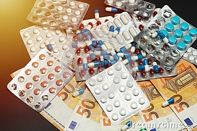 Euro money banknotes and pills. Expensive treatment. Medical care cost concept. Stock Photo