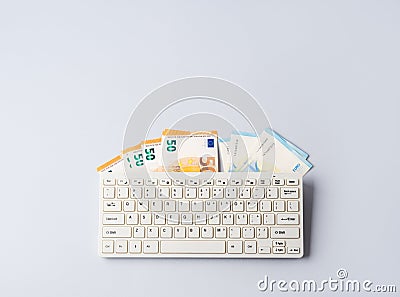 Euro money banknotes under keyboard, online banking, sale of digital info products concept Stock Photo