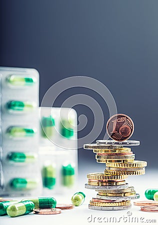 Euro money and medicaments. Euro coins and pills. Coins stacked on each other in different positions and freely pills around Stock Photo