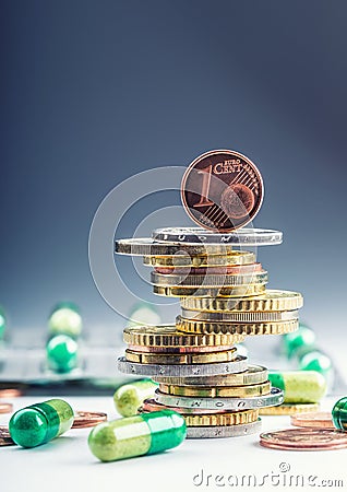 Euro money and medicaments. Euro coins and pills. Coins stacked on each other in different positions and freely pills around Stock Photo