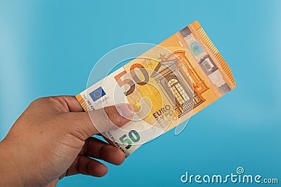 50 Euro note on hand on blue background Stock Photo