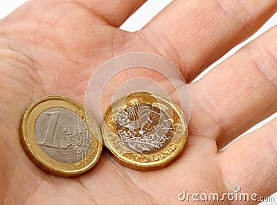 Euro and pound coins in palm of hand Editorial Stock Photo