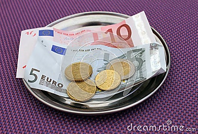 Euro tips on restaurant table Stock Photo