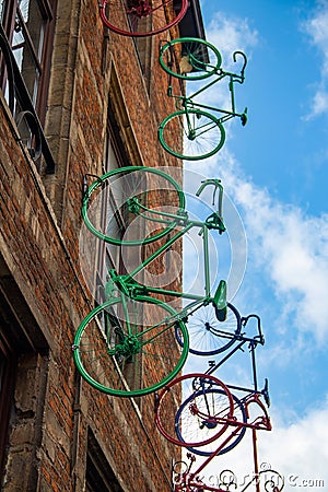 Europe, Belgium, Brussels, artwork, facade art, colorful sprayed bicycles mounted on a brick house facade Editorial Stock Photo