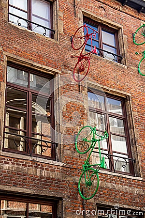 Europe, Belgium, Brussels, artwork, facade art, colorful sprayed bicycles mounted on a brick house facade Editorial Stock Photo