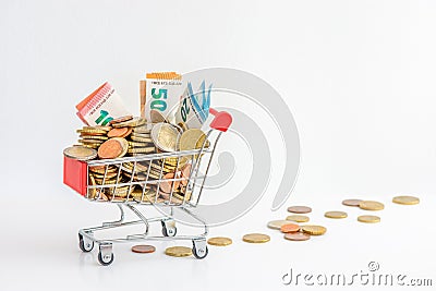 Europe: Shopping cart overflowing with cash euro coins and banknotes Stock Photo