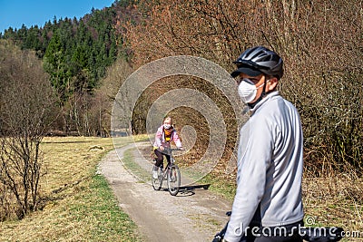 EUROPE - Slovakia, 25. May 2020: Old Woman Cycling with a Mask on her Face Editorial Stock Photo