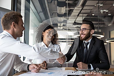 European and arabian businessmen shake hands finishing successful negotiations Stock Photo