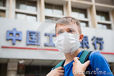 European boy in a protective mask on a street in Beijing Editorial Stock Photo