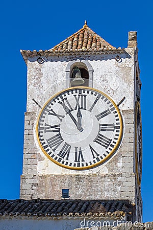 European church with tower and huge clock Stock Photo