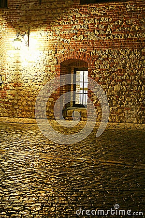 European cobbled street with lantern and window by night Stock Photo